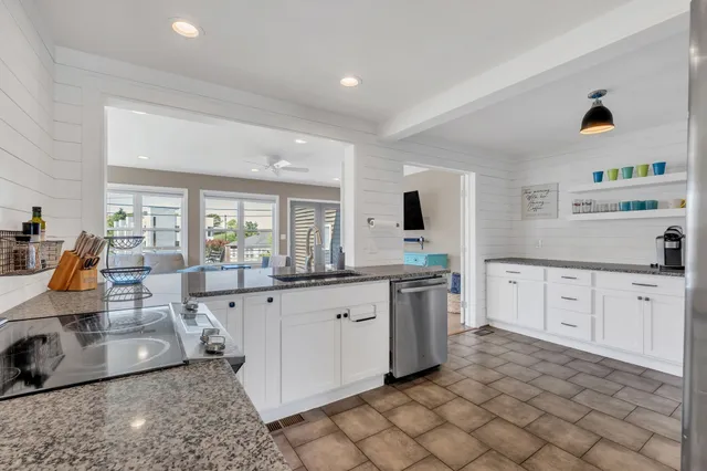 a bathroom with a granite countertop sink and a washing machine