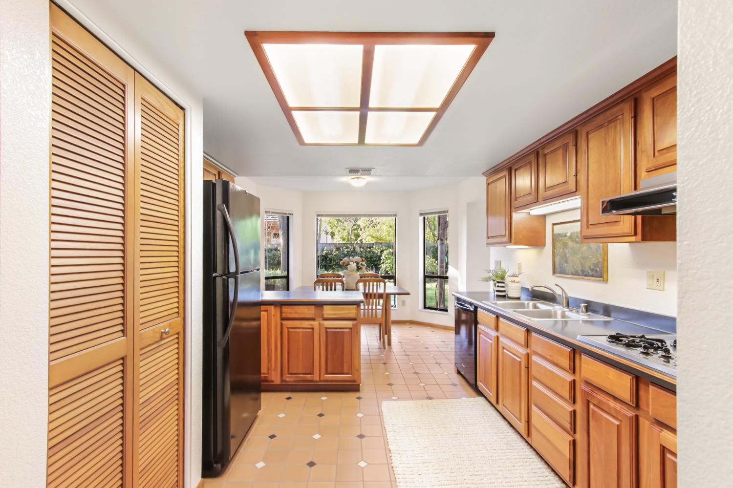 2216 Bryce Lane Davis, CA 95616 - Photo 13 of 53 a large kitchen with stainless steel appliances granite countertop a stove a sink and a refrigerator