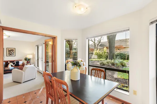 a view of a dining room with furniture large windows and wooden floor