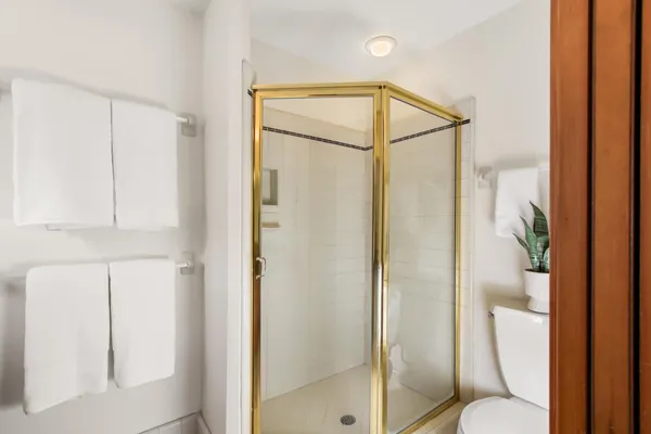 a bathroom that has a glass shower door