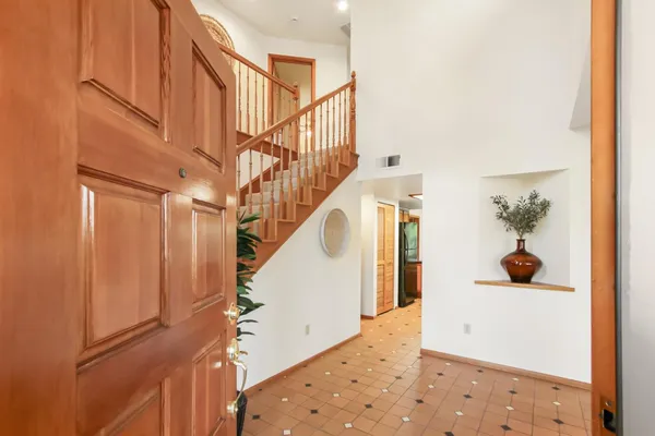 a view of entryway and hall with wooden floor