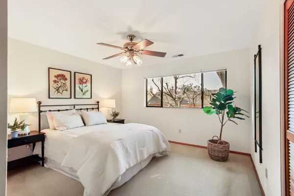 a bedroom with a bed and a chandelier