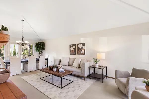 a living room with furniture and a floor to ceiling window
