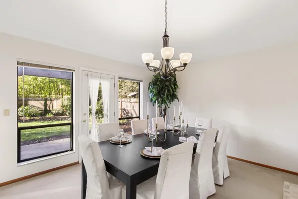 a view of a dining room with furniture wooden floor and chandelier