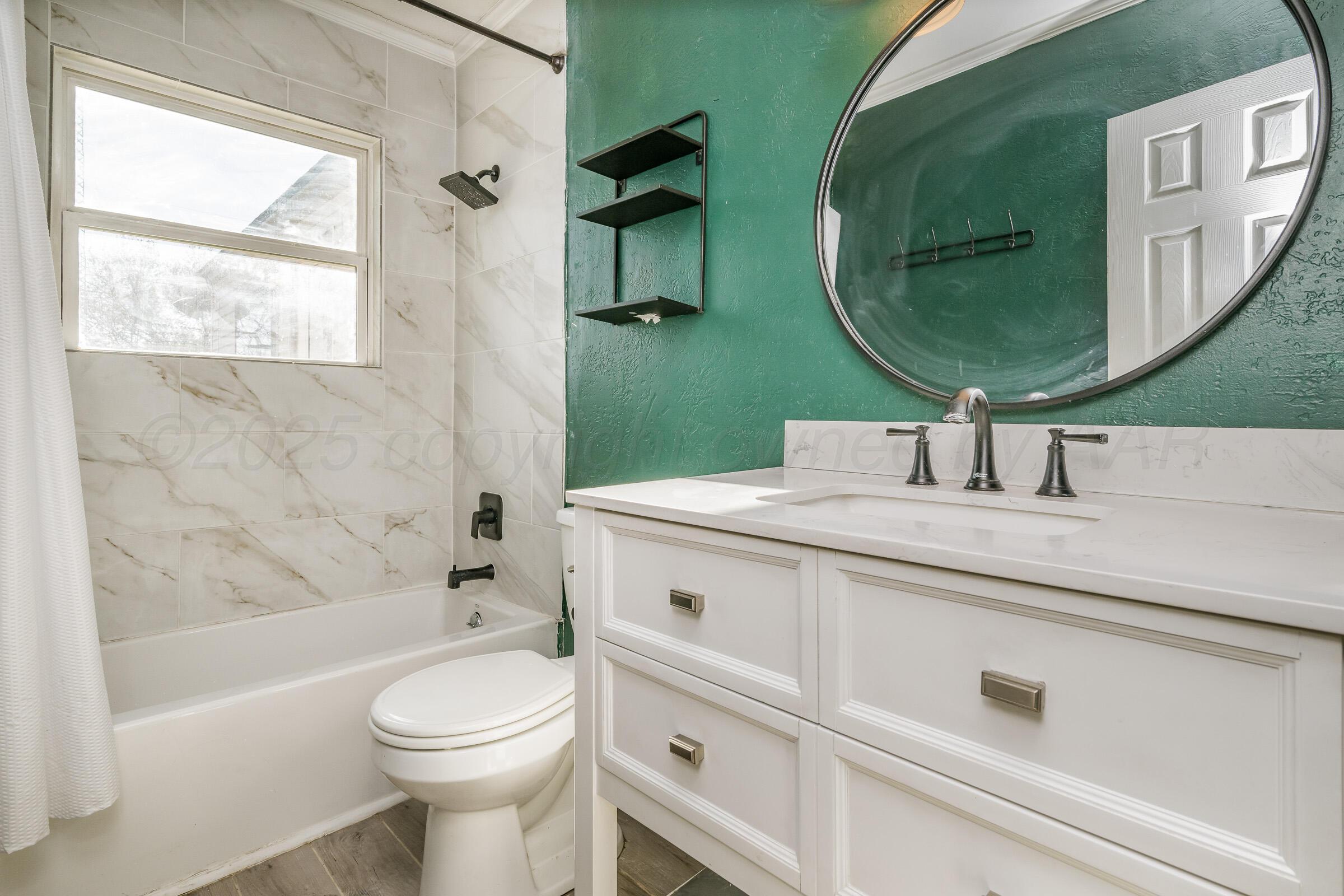 4929 Southwest 16th Avenue Amarillo, TX 79106 - Photo 19 of 19 a bathroom with a sink a toilet and a mirror