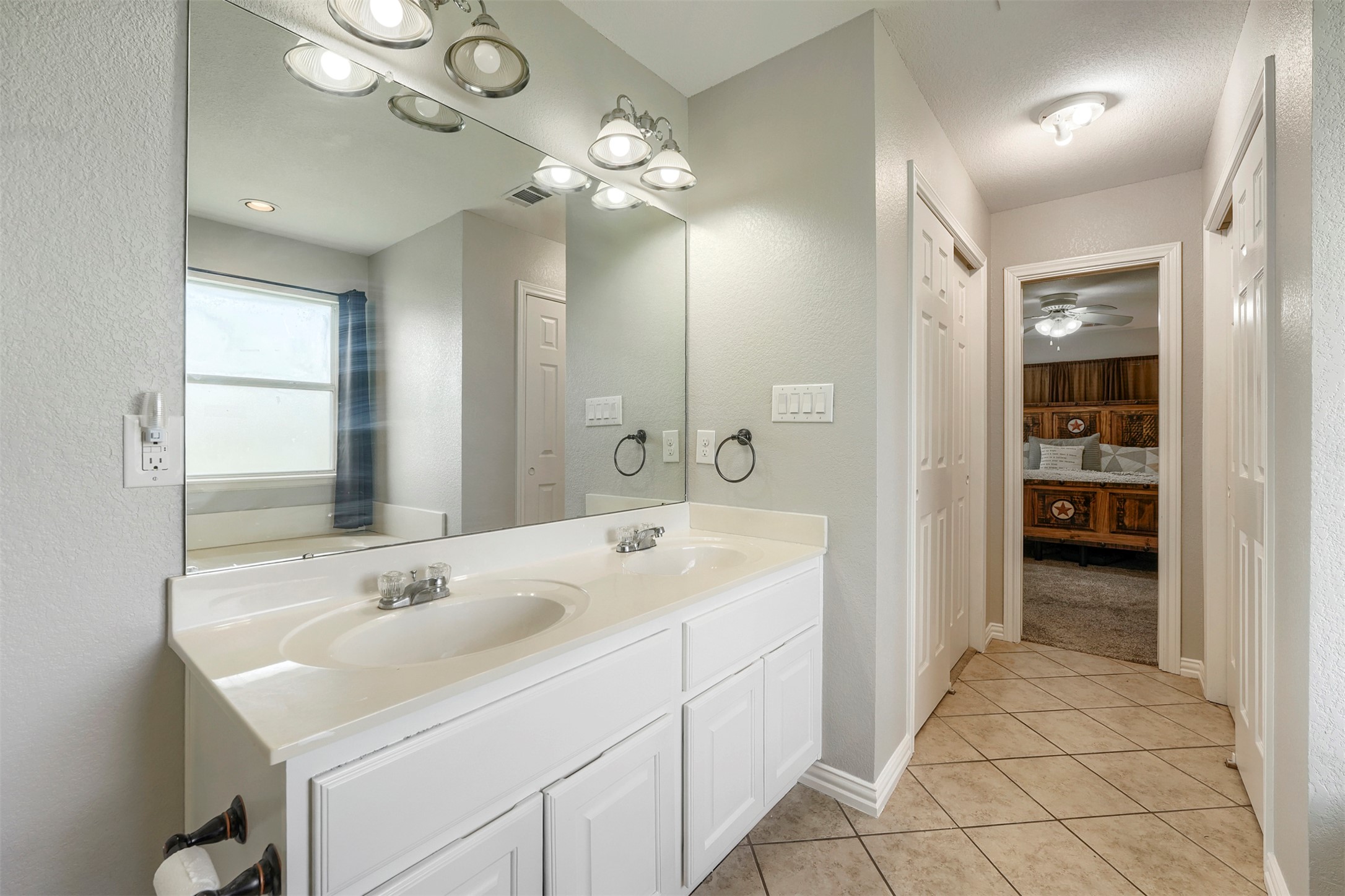 1105 2nd Street Jarrell, TX 76537 - Photo 15 of 27 Double vanities and ample counter space create a functional and pleasant bathing experience.