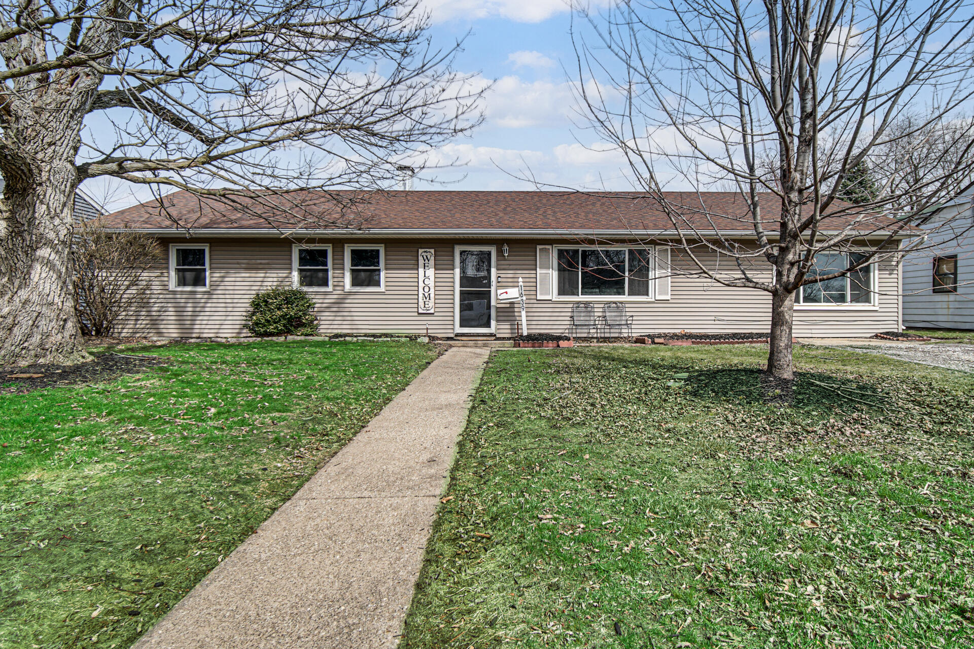 1639 174th Street Hammond, IN 46324 - Photo 1 of 21 a front view of a house with a yard and trees