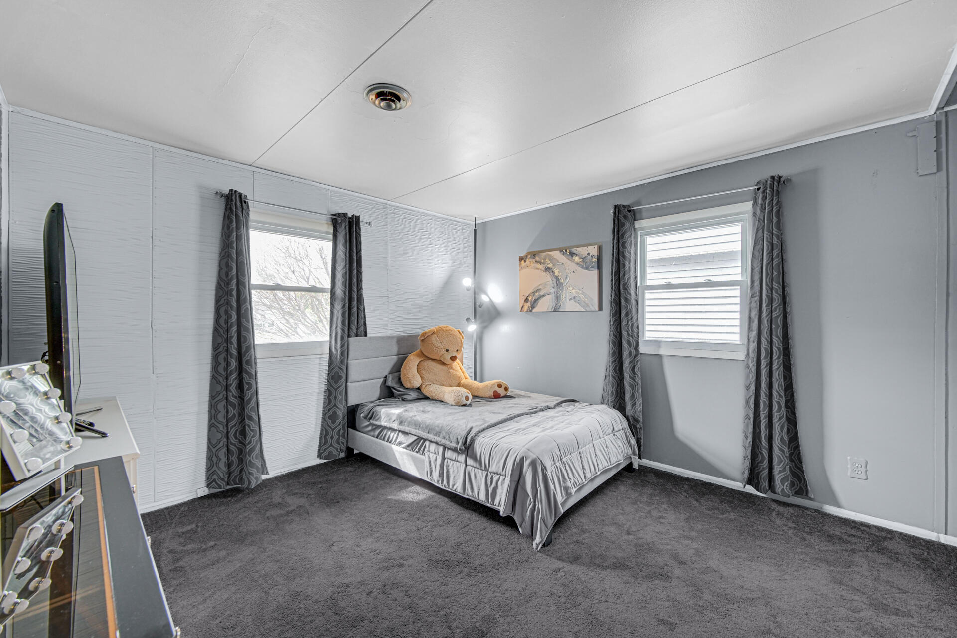 1639 174th Street Hammond, IN 46324 - Photo 12 of 21 a bedroom with a bed and a flat tv screen on the dresser