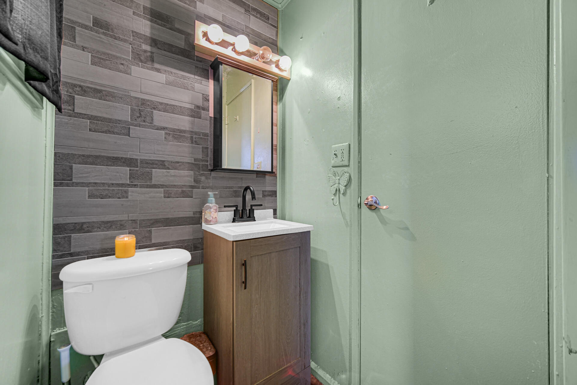 1639 174th Street Hammond, IN 46324 - Photo 16 of 21 a bathroom with a toilet sink and mirror