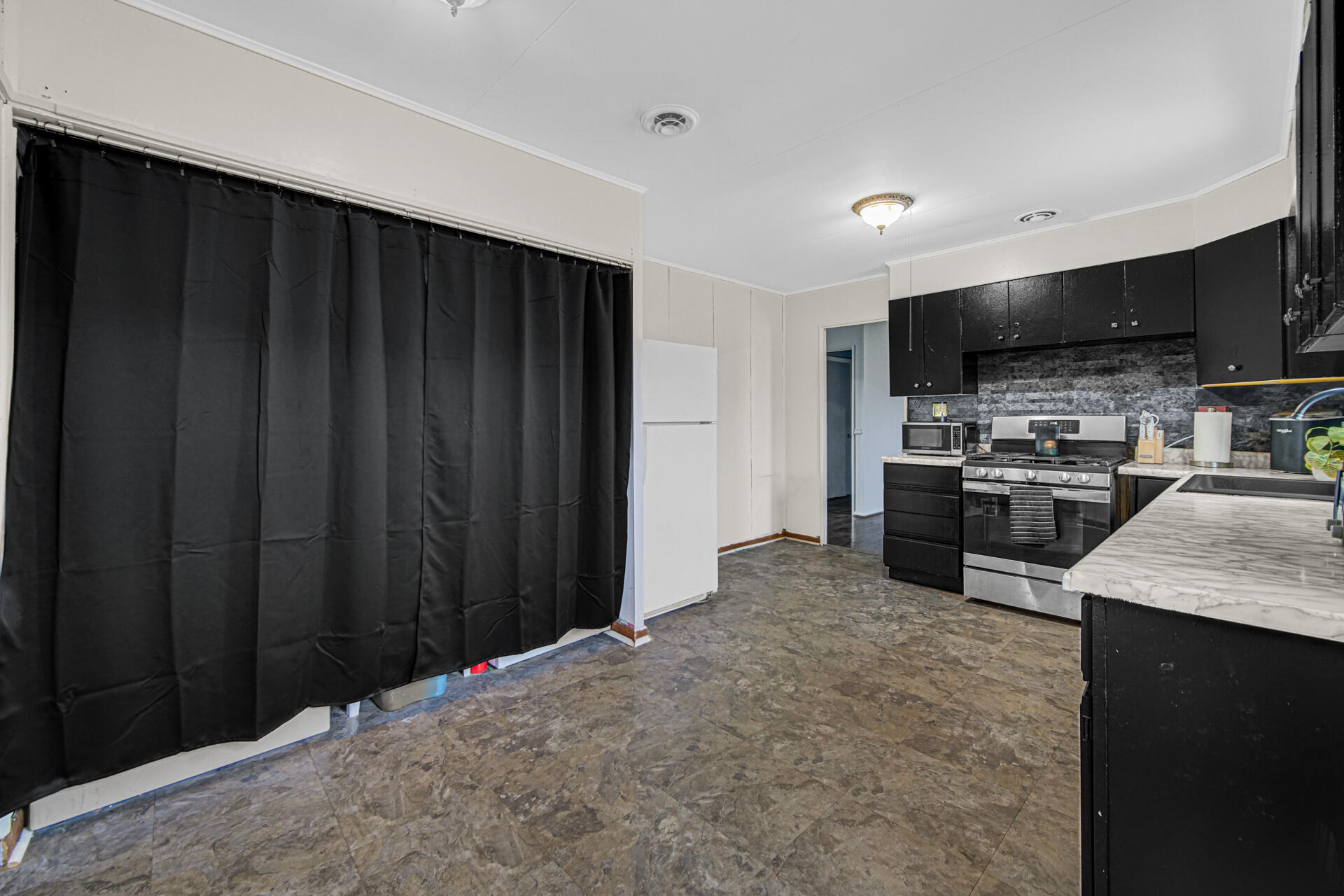 1639 174th Street Hammond, IN 46324 - Photo 4 of 21 a kitchen with stainless steel appliances granite countertop a refrigerator and a stove
