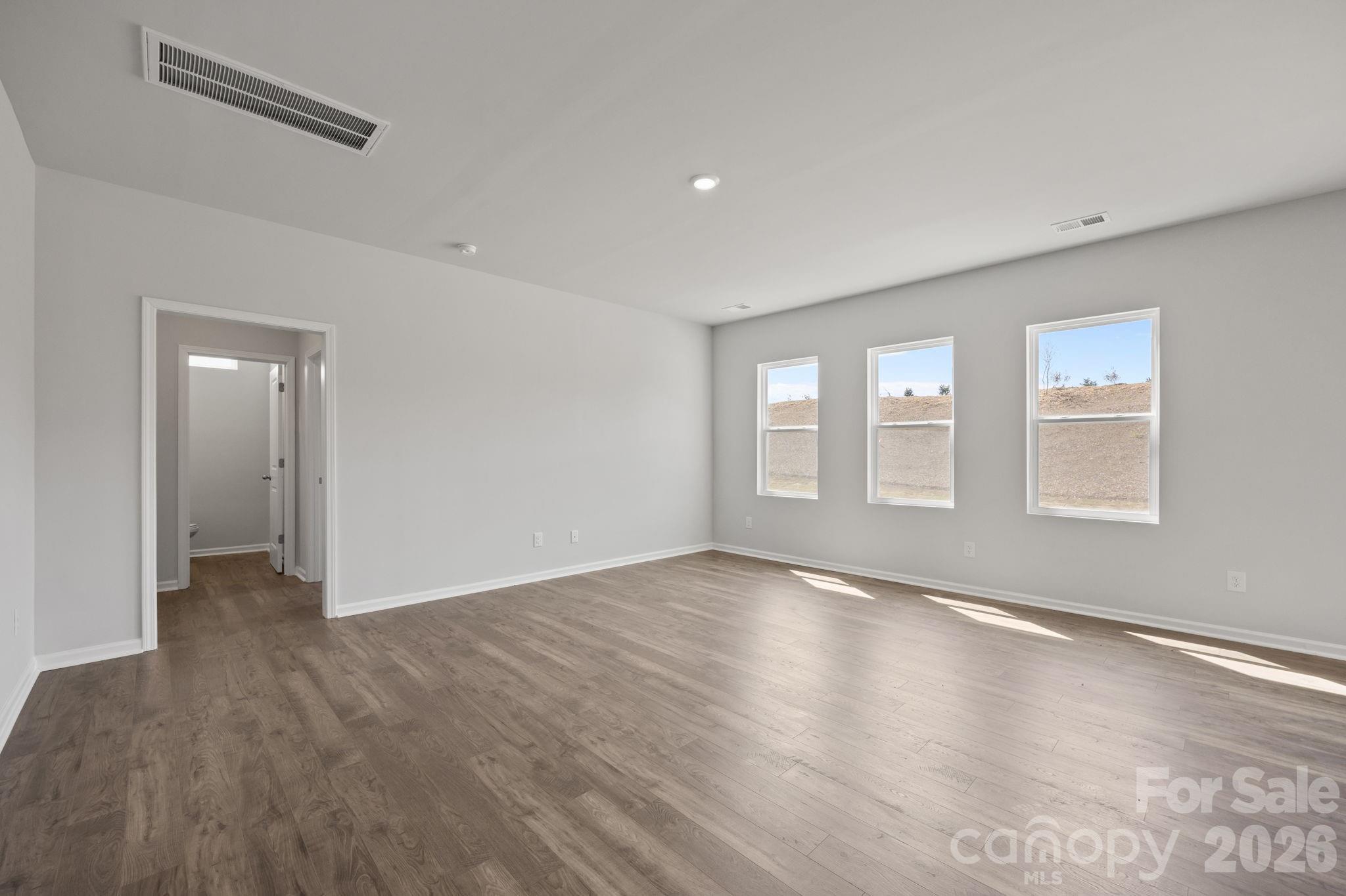 426 Brick House Road York, SC 29745 - Photo 18 of 35 a view of an empty room with wooden floor and a window