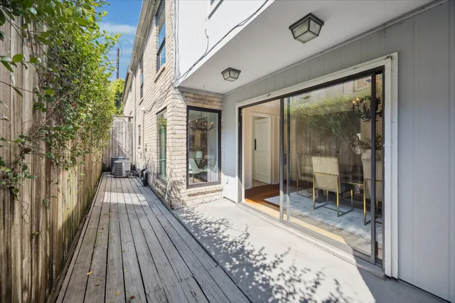 a view of a balcony with wooden floor and iron stairs