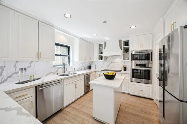 a kitchen with a sink and white cabinets