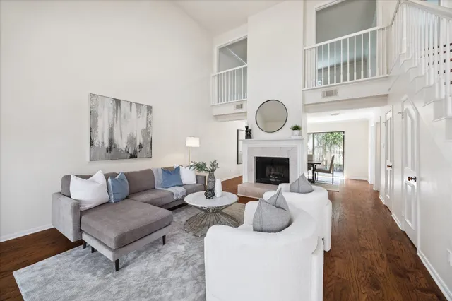 a living room with furniture a fireplace and a rug