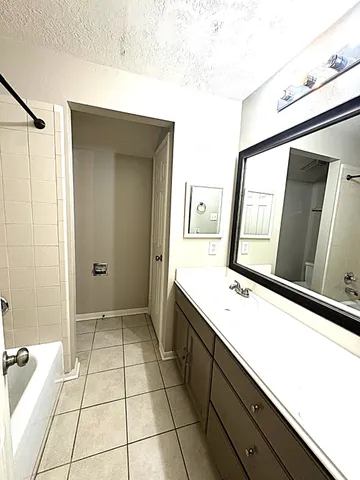 a bathroom with a sink a mirror and a shower