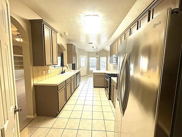 a bathroom with a tub a sink and a mirror