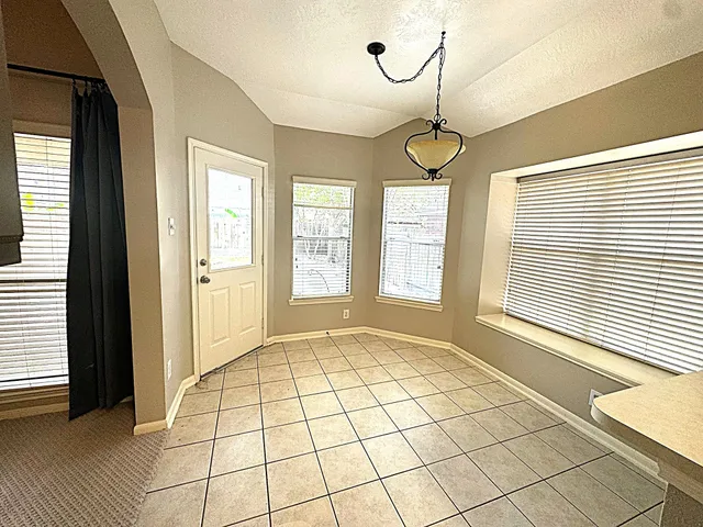 a view of an empty room with windows