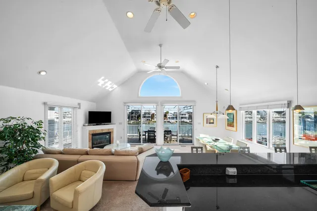 a living room with furniture kitchen and a chandelier