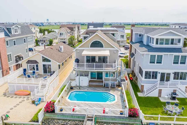 a aerial view of buildings with yard and mountain view