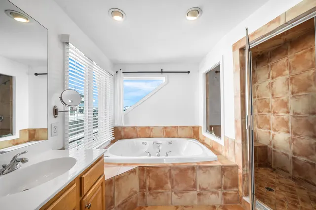 a bedroom with furniture and a window