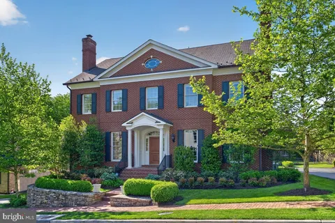 a front view of a house with a yard and outdoor seating
