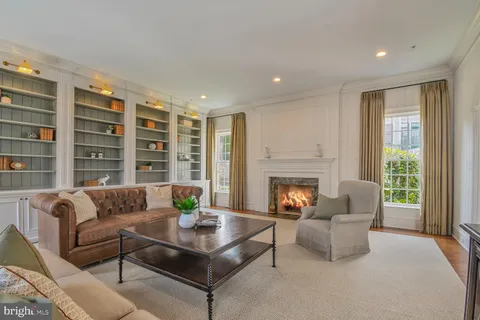 a view of a hallway with closet and a fireplace