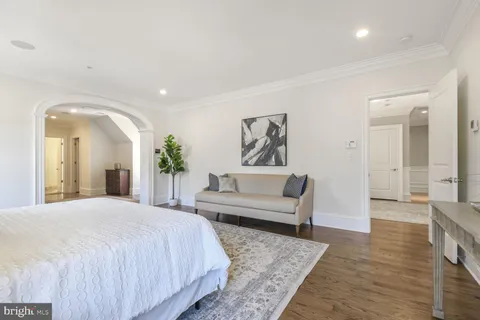 a bedroom with a large bed and a window