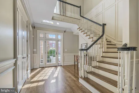 a view of a a dining room with furniture window and wooden floor