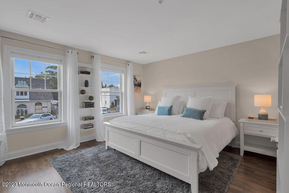 308 Morris Avenue, Unit A Spring Lake, NJ 07762 - Photo 18 of 37 a bedroom with a large bed a rug and windows