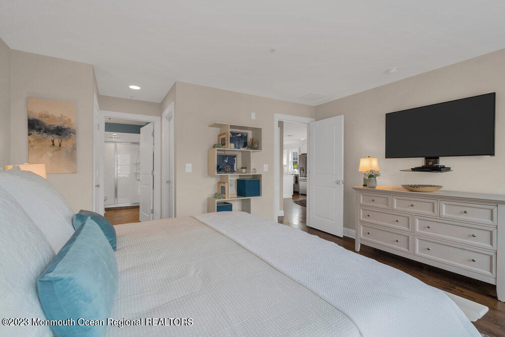 308 Morris Avenue, Unit A Spring Lake, NJ 07762 - Photo 19 of 37 a bedroom with a bed and a flat screen tv