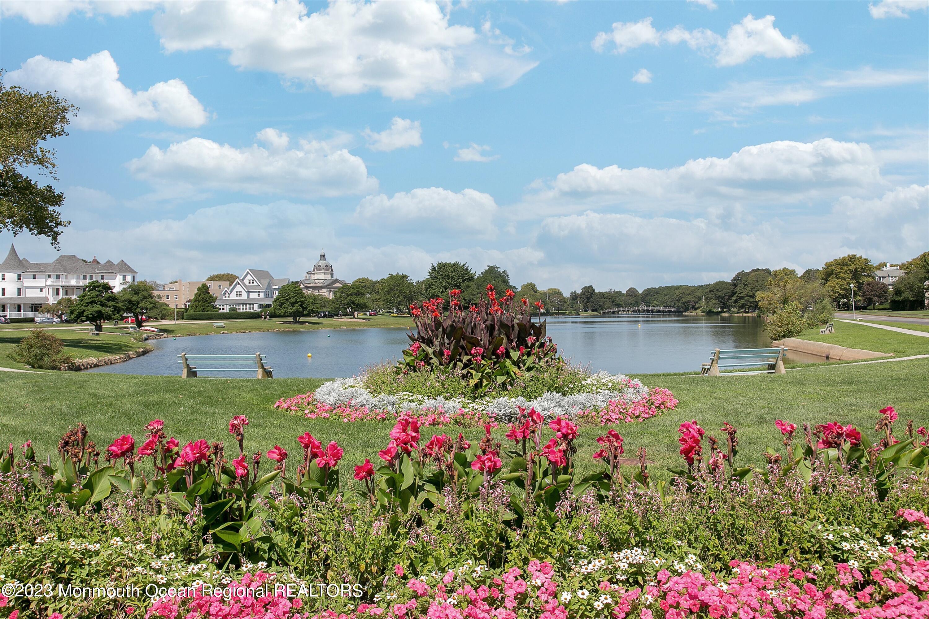 308 Morris Avenue, Unit A Spring Lake, NJ 07762 - Photo 32 of 37 a view of a lake with a flower garden and swimming pool