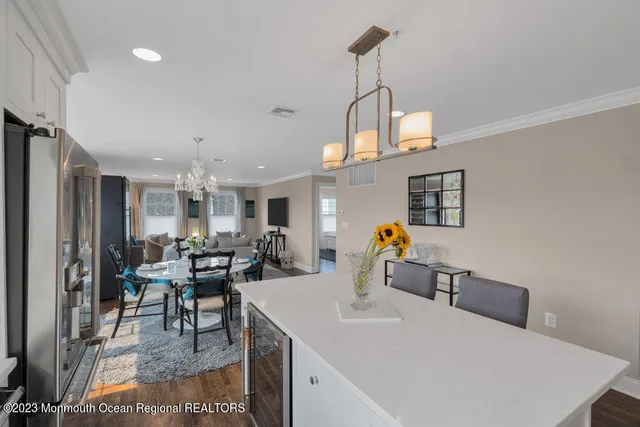 a living room with furniture a dining table and chairs