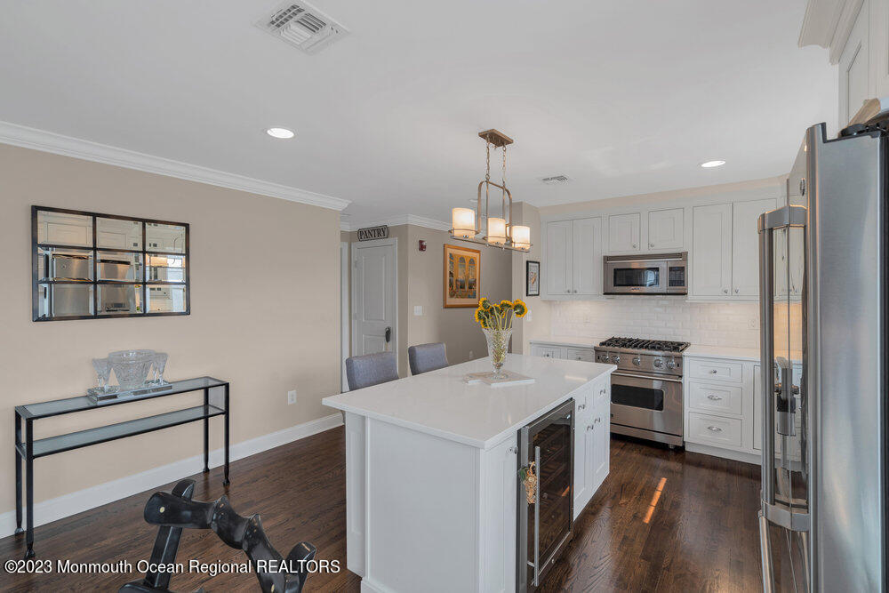308 Morris Avenue, Unit A Spring Lake, NJ 07762 - Photo 7 of 37 a kitchen with a sink stainless steel appliances and cabinets