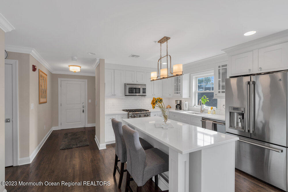 308 Morris Avenue, Unit A Spring Lake, NJ 07762 - Photo 8 of 37 a kitchen with stainless steel appliances a sink stove and refrigerator