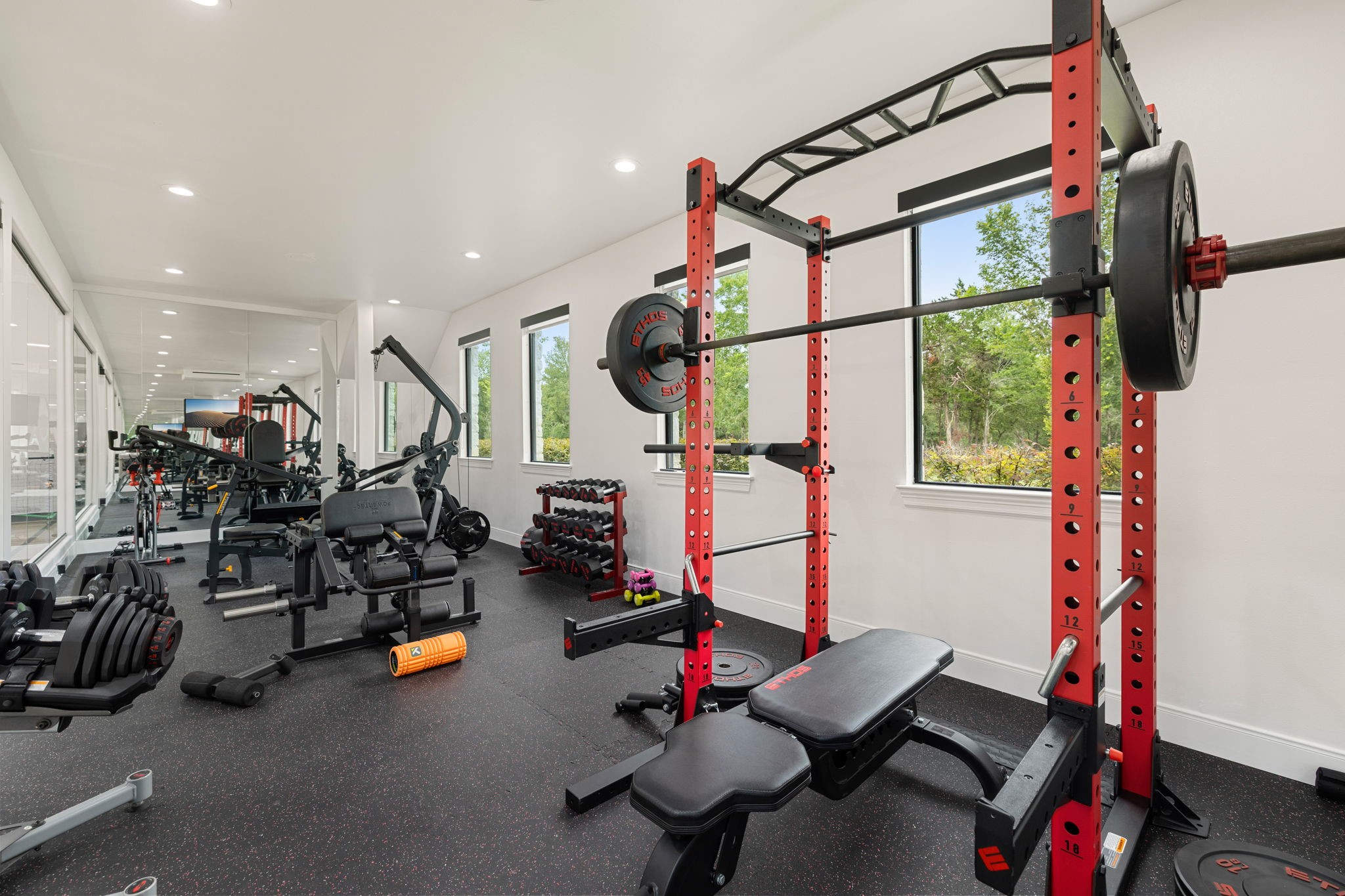 1100 Felder Road Washington, TX 77880 - Photo 37 of 50 This bright, dedicated home gym offers a spacious, professional-caliber workout environment, with mirrored walls and large windows bringing in abundant natural light throughout.