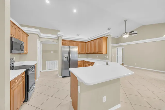 a large kitchen with cabinets and stainless steel appliances