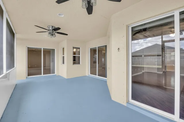 a view of empty room with windows and cabinet