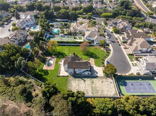 an aerial view of a house with a garden and lake view