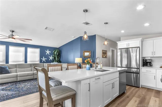 a kitchen with counter top space sink stove and refrigerator
