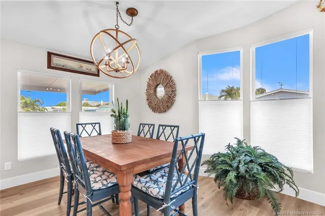 a bedroom with a large bed and a potted plant