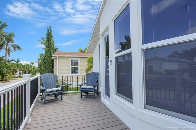 a balcony with furniture and wooden floor