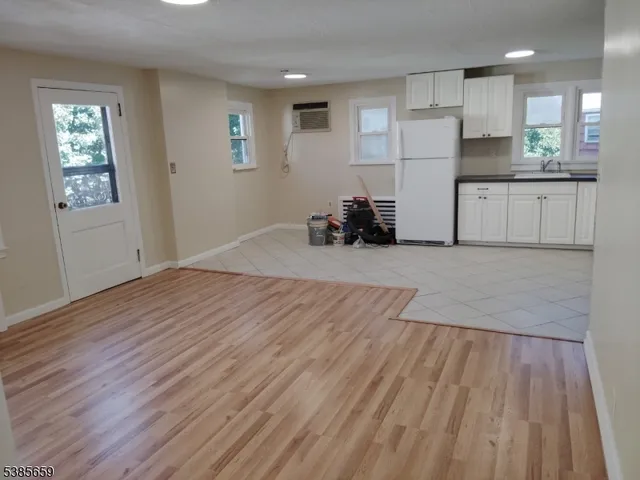 a view of a kitchen with cabinets and wooden floor