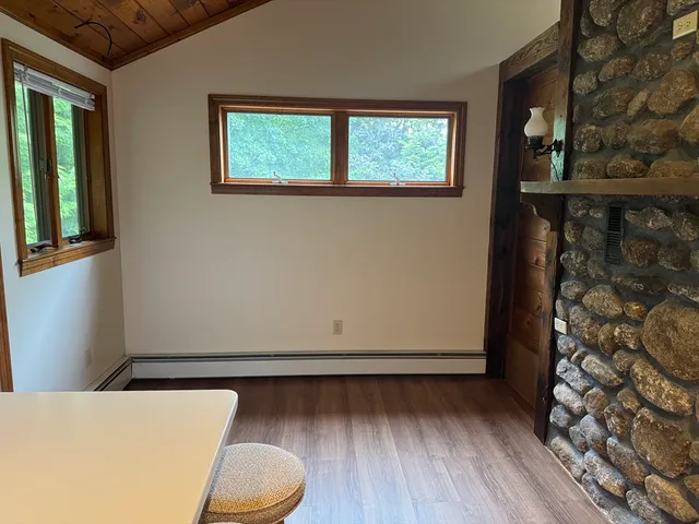 a view of room with window and wooden floor