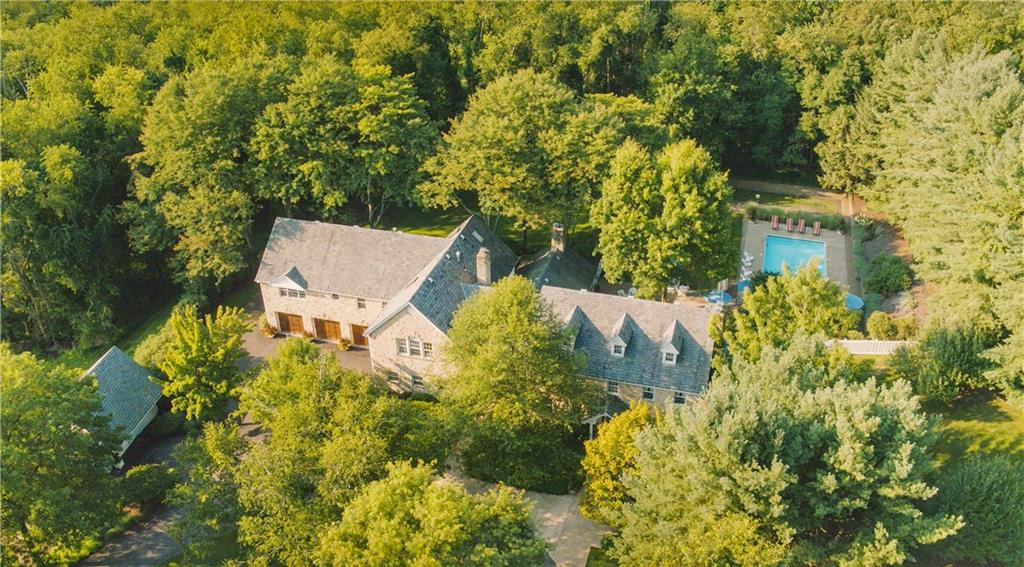 2390 Fairhill Road Sewickley, PA 15143 - Photo 1 of 25 Stunning 8.28 Acre Estate backing to Wooded Greenspace. The Main Residence is nestled among majestic trees & rolling hills featuring a Governors Driveway, Stone Faade, Resort Style Rear Yard, Entertaining Patio, Inground Pool, Bocce Court, Wisteria Covered Pergola, 3 Car Attached Garage, spacious Bonus Bedroom Apartment/Mother-in-Law Suite with Private Entrance