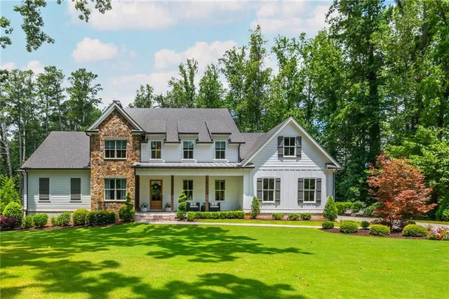 a front view of a house with a garden