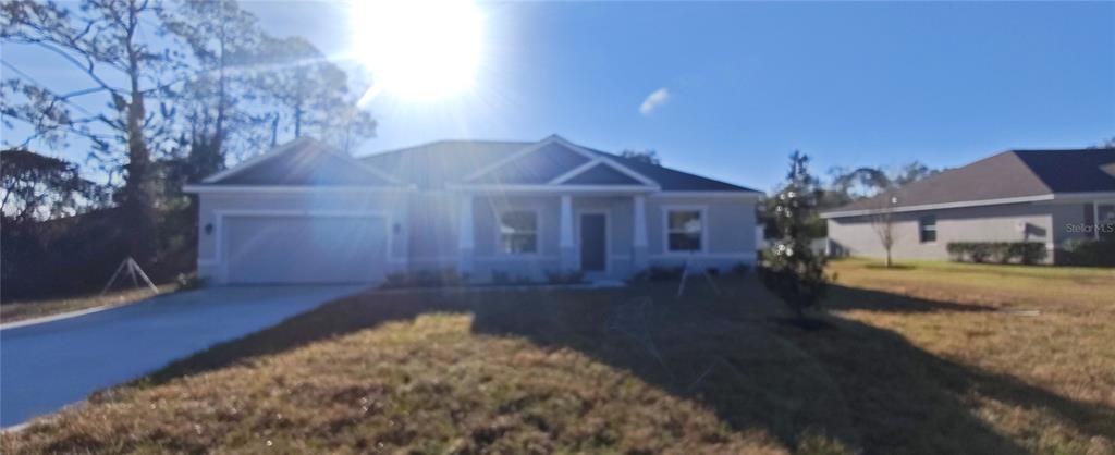 75 Kankakee Trail Palm Coast, FL 32164 - Photo 1 of 11 a front view of a house with a yard