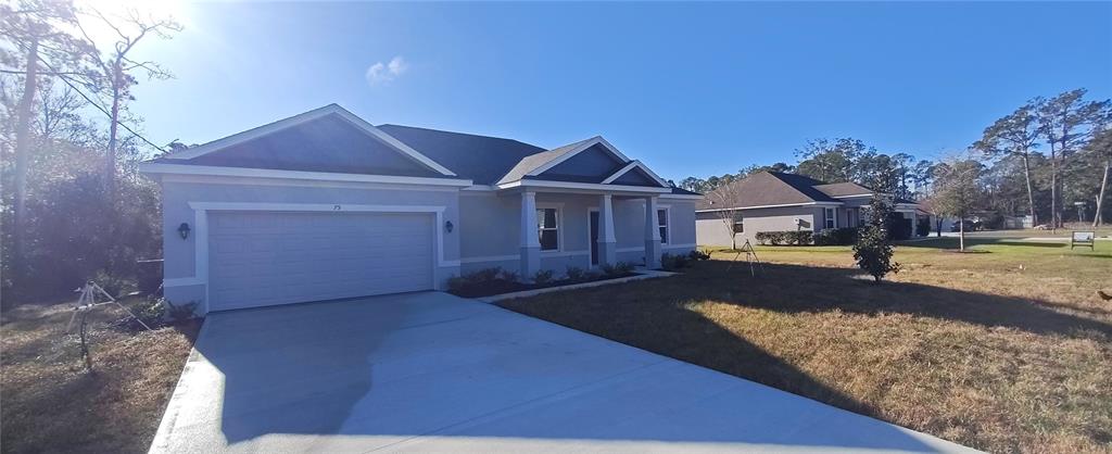 75 Kankakee Trail Palm Coast, FL 32164 - Photo 2 of 11 a front view of a house with yard
