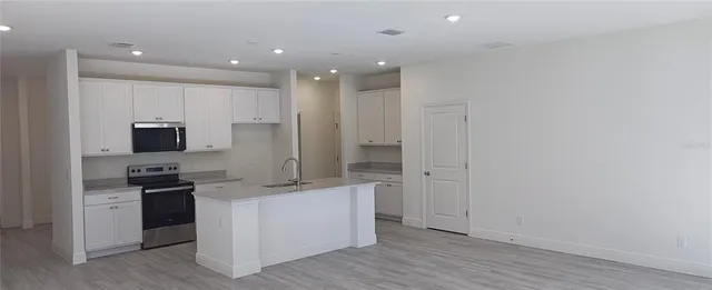 a view of a kitchen with electric appliances