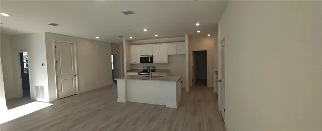 a kitchen with stainless steel appliances a refrigerator and a stove top oven