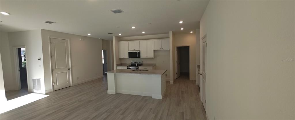 75 Kankakee Trail Palm Coast, FL 32164 - Photo 4 of 11 a kitchen with stainless steel appliances a refrigerator and a stove top oven